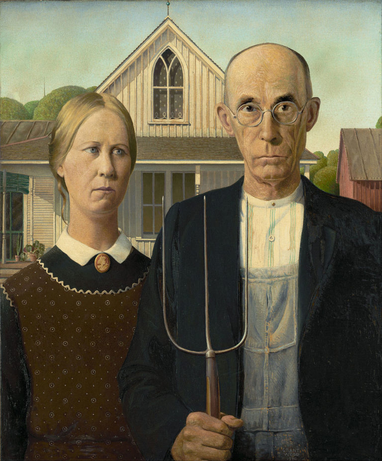 In this classic painting by Grant Wood, a man and woman in austere clothing, with serious facial expressions, stand stiffly in front of a barn. The man holds a pitchfork, while the woman holds a concerned facial expression.