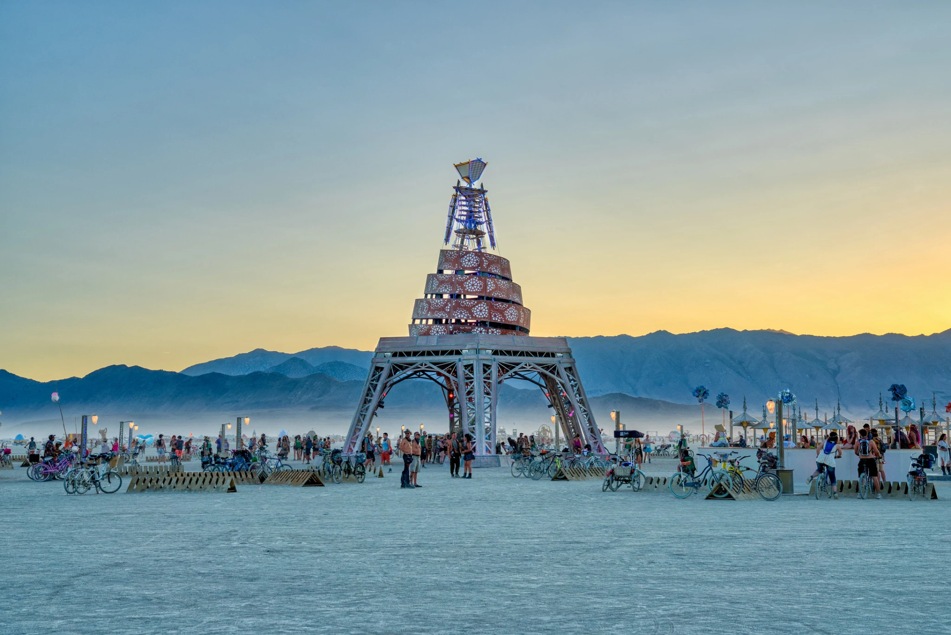 A Burning Man sculpture set against the twilight sky