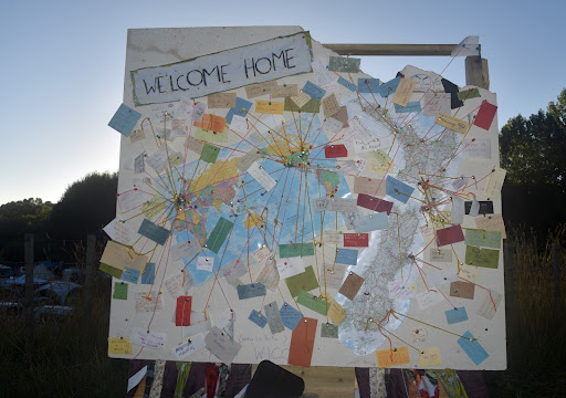 A large notice board with a map of Kiwiburn, lots of notes and the Title "Welcome Home"