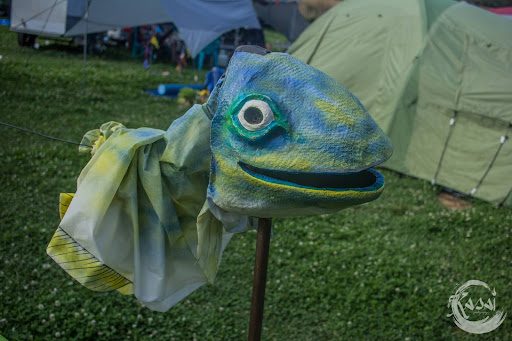 A smiling fish head on a stick sits proudly as Paddock Art