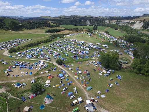A birds eye view of Kiwiburn with a spread of tents amongst the green scenery