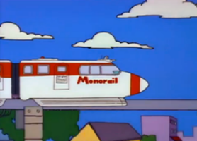A red and white cartoon train with the word 'Monorail' on its front end sits on tracks high in the air with blue sky in the background