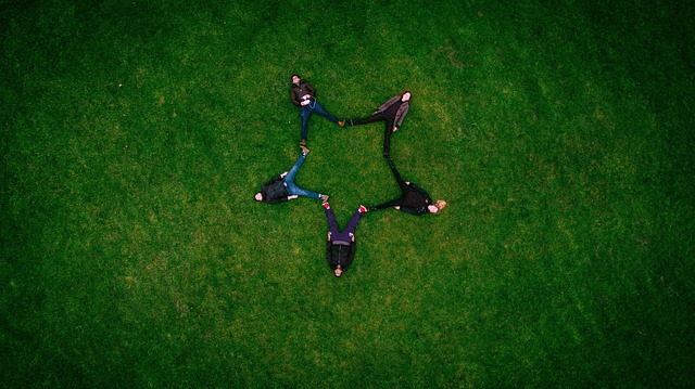 An image of 5 people forming a star with their legs.