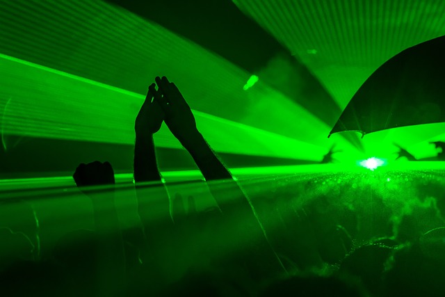 An image of a laser light with people dancing.
