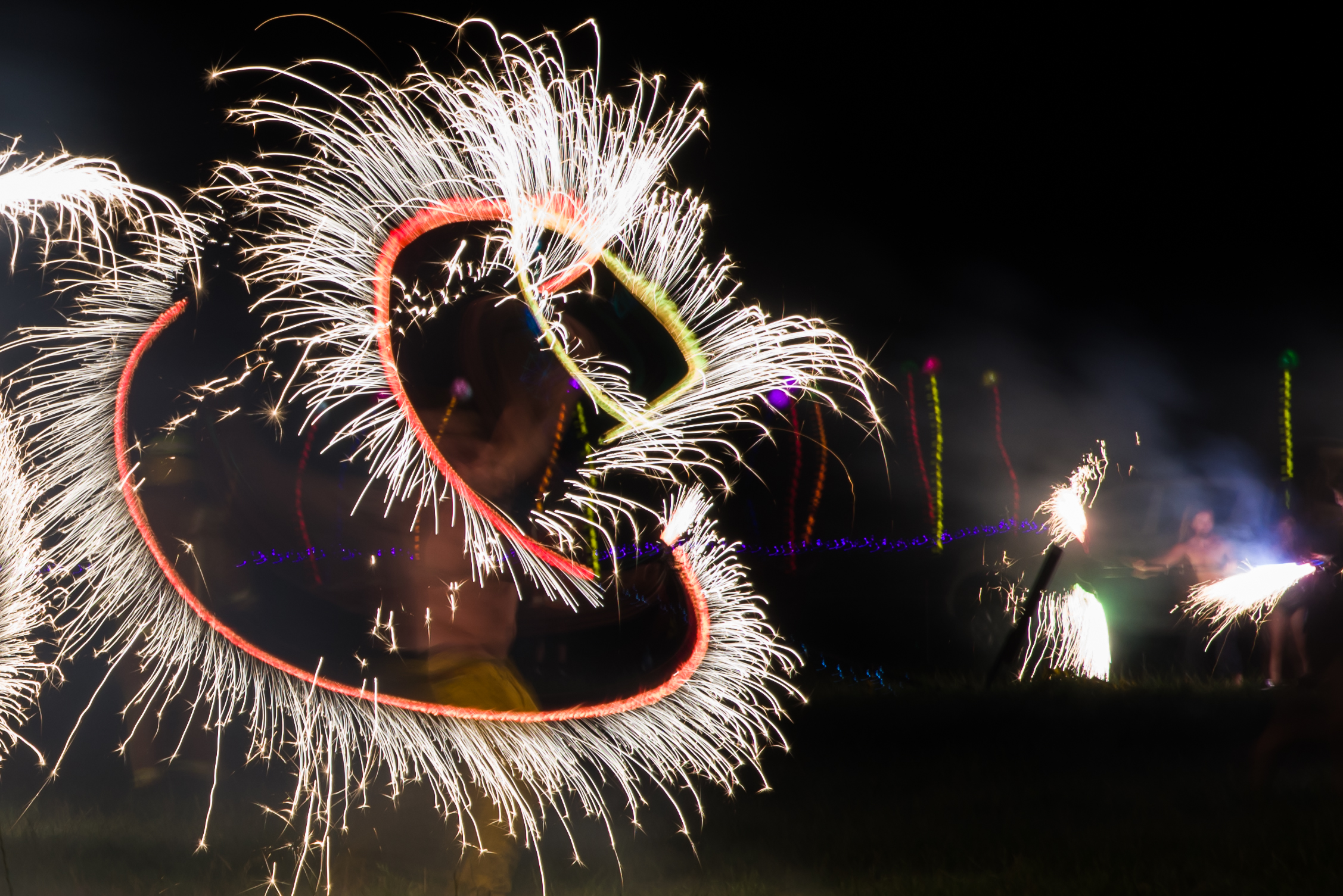 a sparkling swirl of fire spinning against a dark backdrop