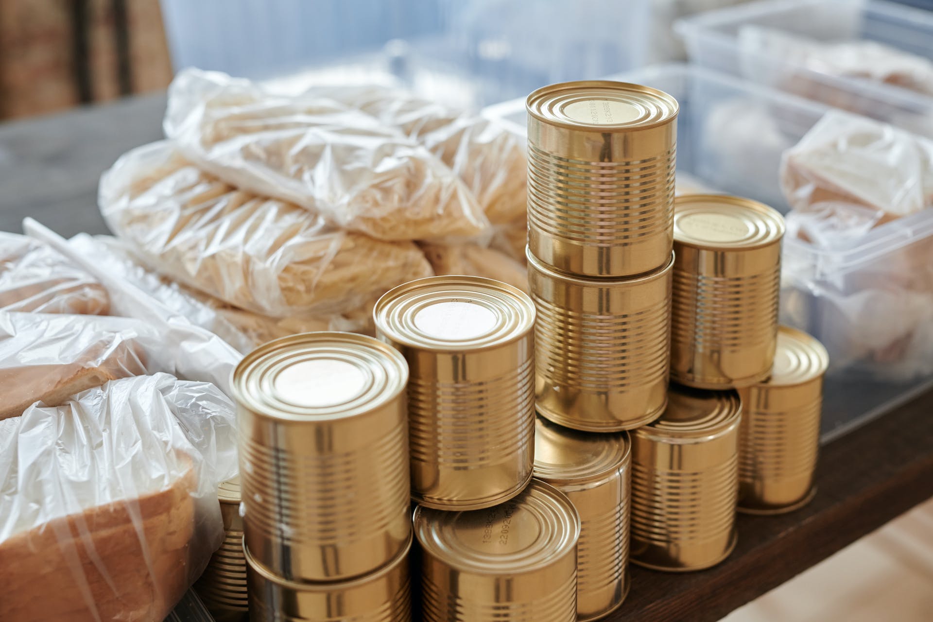 a stack of tinned food and packaged foot sits on a table