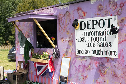 a pinkinsh shack with a fold out window and a sign stating 'DEPOT'