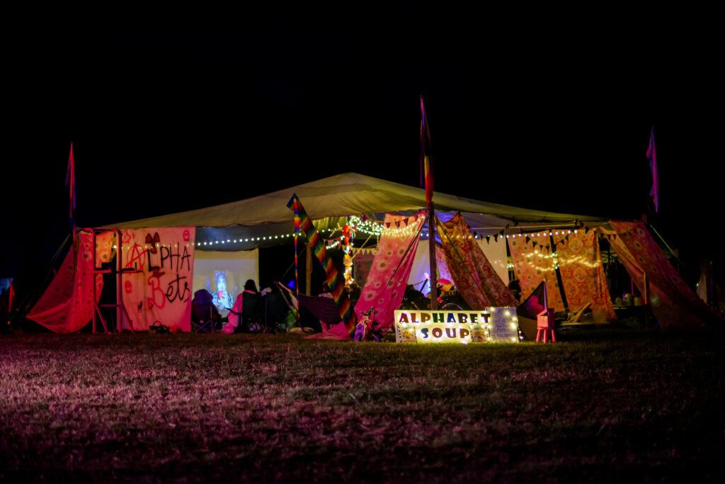 The Theme Camp Alphabet Soup, with glittering lights and a big sign that says Alphabet Soup