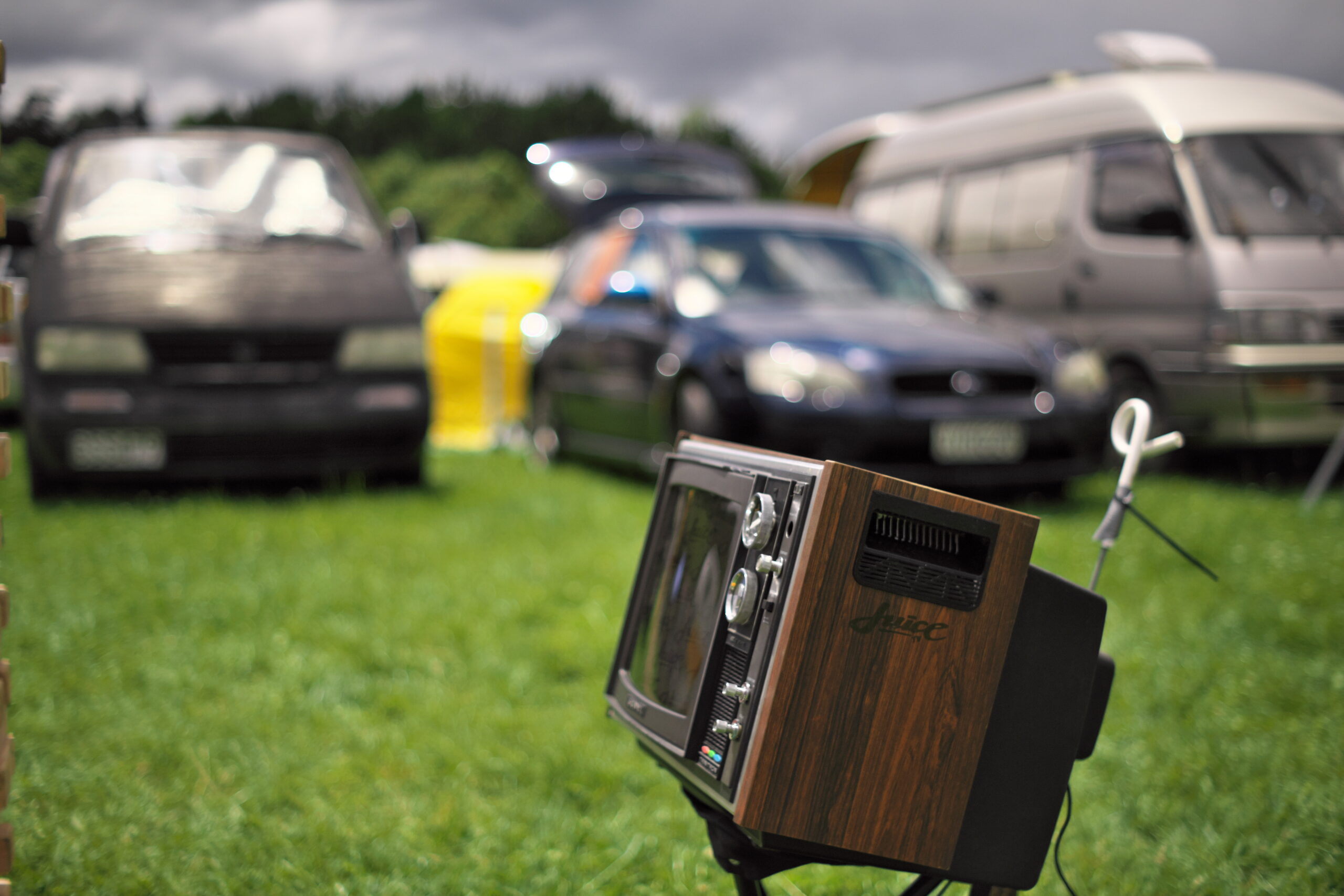 An image of a TV in front of cars.