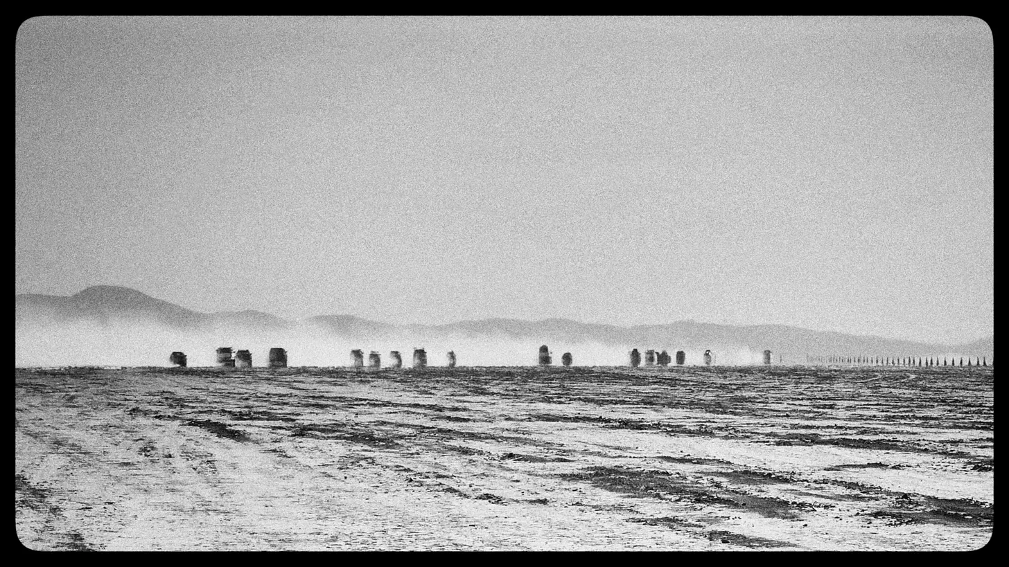 First spike big burn A black and white photo of the empty Nevada desert with silhouettes in the distance