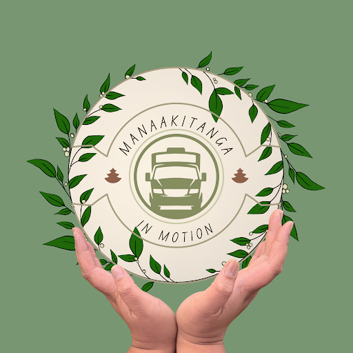 Hands holding a lead adorned plate saying "Manaakintanga in Motion" on a green background